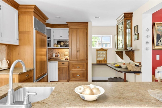 44 Bridge St, Bucksport, ME 04416 - kitchen with a sink, paneled refrigerator, tasteful backsplash, and brown cabinetry