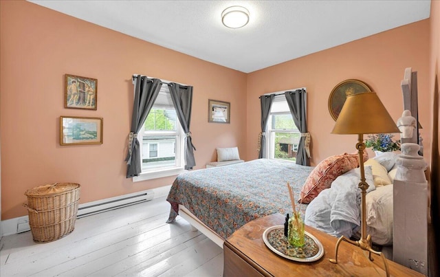 44 Bridge St, Bucksport, ME 04416 - bedroom with a baseboard radiator, hardwood / wood-style flooring, and baseboards