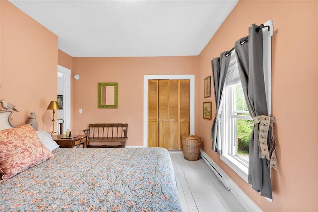 44 Bridge St, Bucksport, ME 04416 - bedroom with baseboard heating, light wood-style floors, and a closet