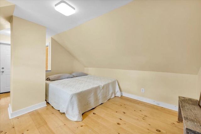 44 Bridge St, Bucksport, ME 04416 - bedroom with vaulted ceiling, light wood finished floors, and baseboards