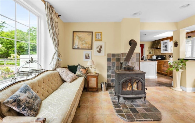 44 Bridge St, Bucksport, ME 04416 - living area with a wood stove and baseboards