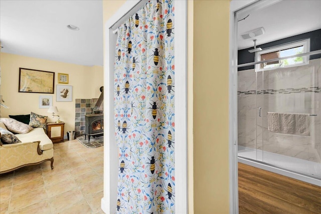 44 Bridge St, Bucksport, ME 04416 - bathroom with a stall shower and a wood stove