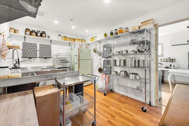 44 Bridge St, Bucksport, ME 04416 - kitchen with wood finished floors, freestanding refrigerator, recessed lighting, and a sink
