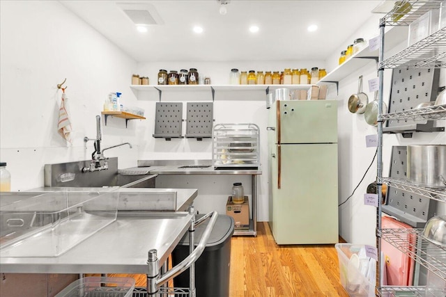 44 Bridge St, Bucksport, ME 04416 - kitchen with freestanding refrigerator, light wood-style floors, open shelves, and recessed lighting
