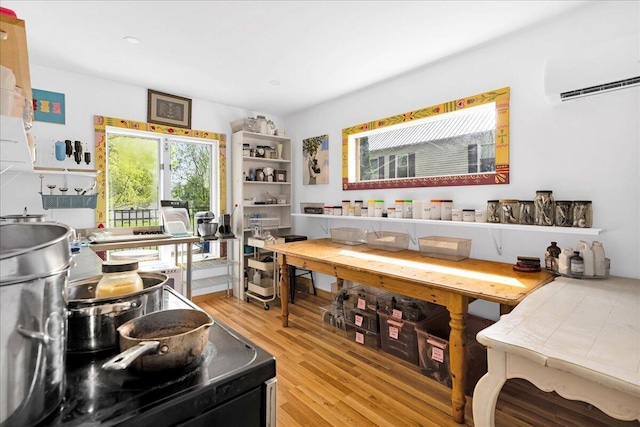 44 Bridge St, Bucksport, ME 04416 - dining room with wood finished floors and a wall mounted AC