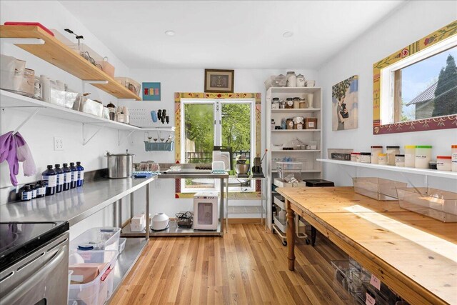 44 Bridge St, Bucksport, ME 04416 - kitchen with open shelves, light wood-style flooring, and stainless steel electric range oven
