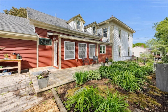 44 Bridge St, Bucksport, ME 04416 - back of house featuring a patio area and roof with shingles