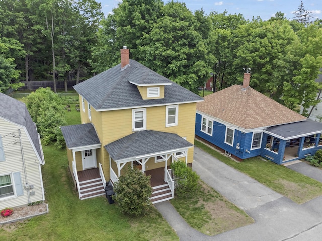 127 Lake St, Auburn, ME 04210 - view of front of property with a porch, a chimney, roof with shingles, driveway, and a front lawn