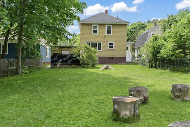 127 Lake St, Auburn, ME 04210 - back of property with a chimney and a shingled roof