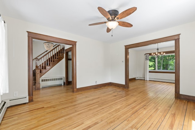 127 Lake St, Auburn, ME 04210 - empty room featuring radiator heating unit, a chandelier, light wood finished floors, stairway, and a baseboard heating unit