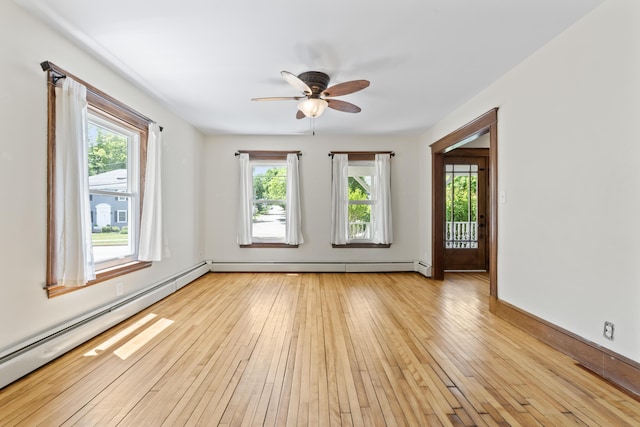 127 Lake St, Auburn, ME 04210 - unfurnished room featuring healthy amount of natural light, ceiling fan, a baseboard radiator, and light wood-style floors