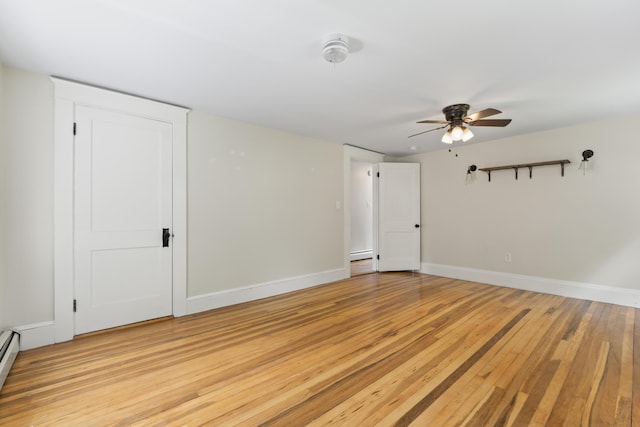 127 Lake St, Auburn, ME 04210 - spare room with light wood-style floors, ceiling fan, baseboards, and baseboard heating