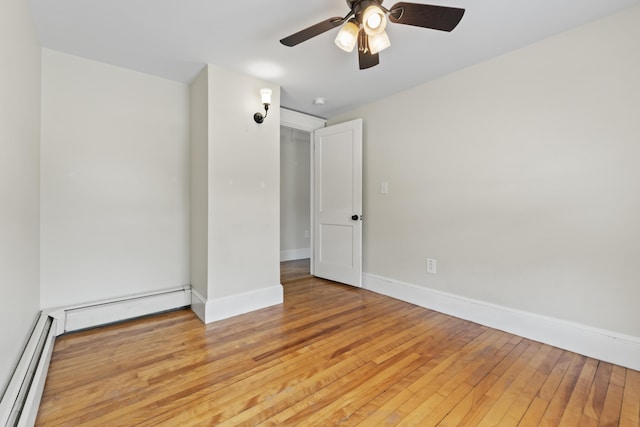 127 Lake St, Auburn, ME 04210 - unfurnished room with a baseboard heating unit, light wood-style flooring, ceiling fan, and baseboards