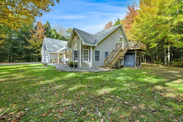 42 Lee Dr, Albion, ME 04910 - rear view of house featuring stairs, a wooden deck, and a lawn