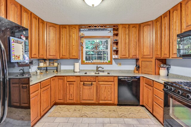 42 Lee Dr, Albion, ME 04910 - kitchen featuring black appliances, a sink, a textured ceiling, plenty of natural light, and brown cabinetry