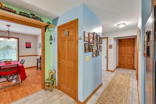 42 Lee Dr, Albion, ME 04910 - foyer entrance with a textured ceiling, light tile patterned floors, and baseboards