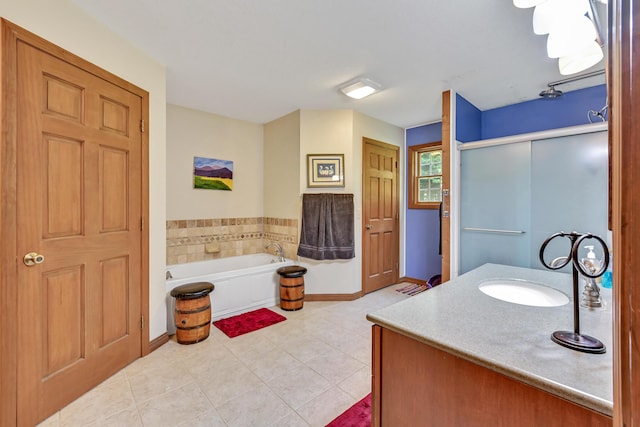 42 Lee Dr, Albion, ME 04910 - full bath with tile patterned flooring, a garden tub, a shower stall, baseboards, and vanity