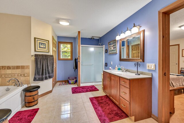 42 Lee Dr, Albion, ME 04910 - full bathroom featuring vanity, a shower stall, a bath, tile patterned floors, and baseboards