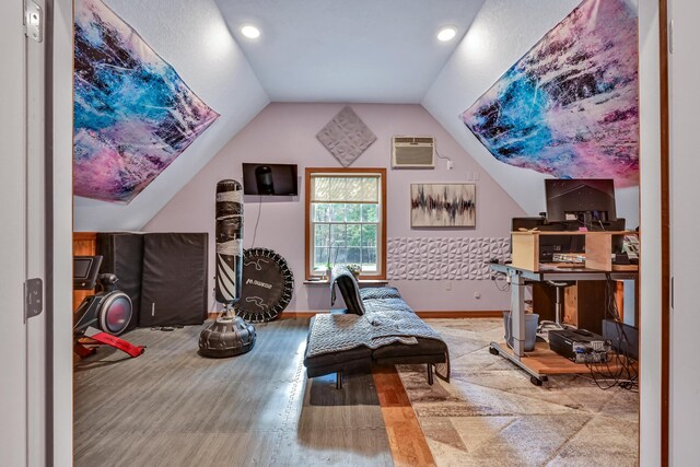 42 Lee Dr, Albion, ME 04910 - exercise room featuring vaulted ceiling, baseboards, a wall unit AC, wood finished floors, and recessed lighting
