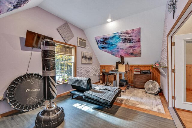 42 Lee Dr, Albion, ME 04910 - living area featuring lofted ceiling, wood finished floors, an AC wall unit, and baseboards