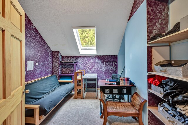 42 Lee Dr, Albion, ME 04910 - carpeted bedroom with wallpapered walls, a skylight, vaulted ceiling, and a textured ceiling
