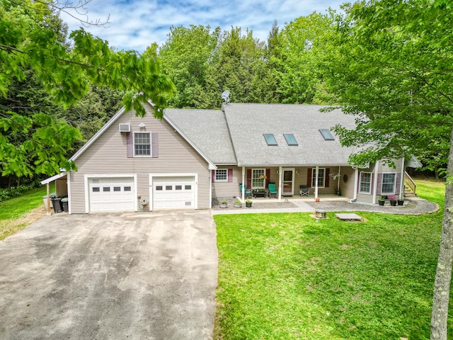 42 Lee Dr, Albion, ME 04910 - cape cod-style house featuring covered porch, asphalt driveway, a front lawn, and a shingled roof