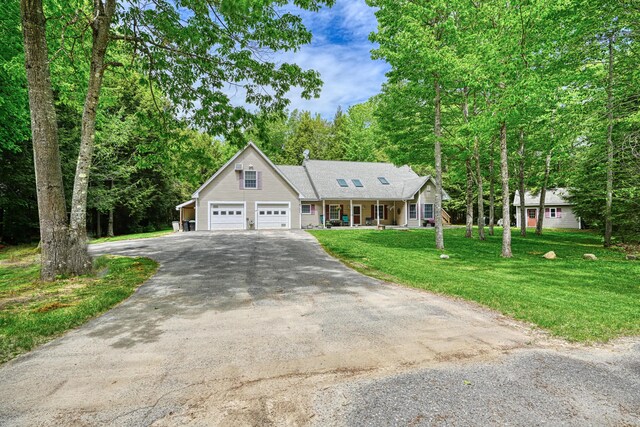 42 Lee Dr, Albion, ME 04910 - view of front of property featuring covered porch, driveway, and a front yard
