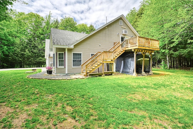 42 Lee Dr, Albion, ME 04910 - back of property with stairway, a deck, roof with shingles, and a lawn
