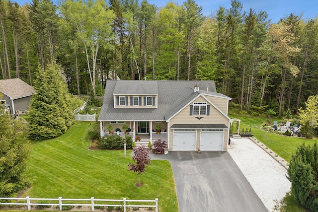 18 Forest Hill Ln, Kennebunk, ME 04043 - view of front of home featuring a porch, asphalt driveway, and a wooded view