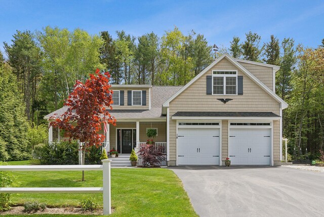 18 Forest Hill Ln, Kennebunk, ME 04043 - view of front of home featuring a porch, a front lawn, driveway, and a shingled roof