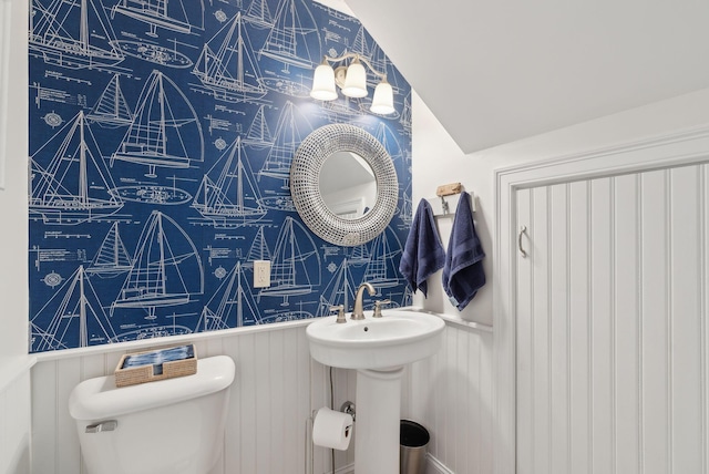 18 Forest Hill Ln, Kennebunk, ME 04043 - half bath featuring toilet, wainscoting, and vaulted ceiling