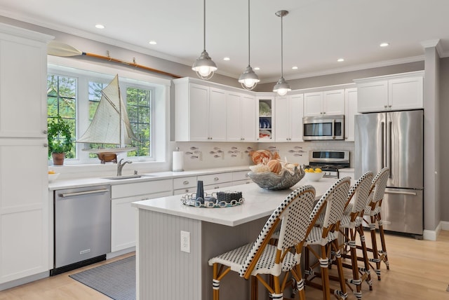 18 Forest Hill Ln, Kennebunk, ME 04043 - kitchen featuring stainless steel appliances, a sink, white cabinetry, crown molding, and decorative backsplash
