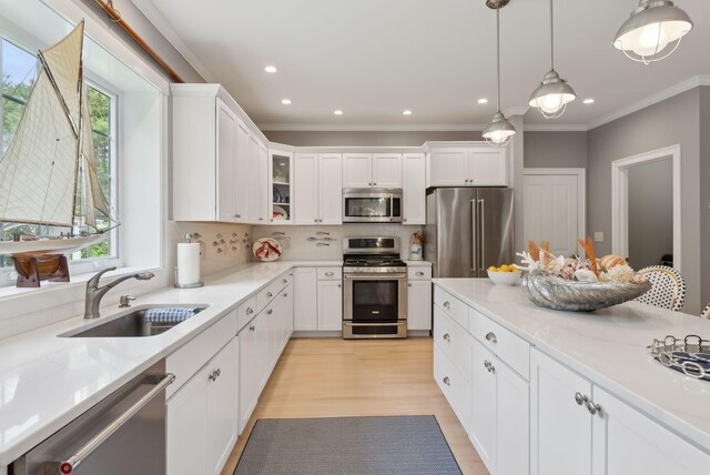 18 Forest Hill Ln, Kennebunk, ME 04043 - kitchen featuring stainless steel appliances, a sink, white cabinets, decorative light fixtures, and glass insert cabinets