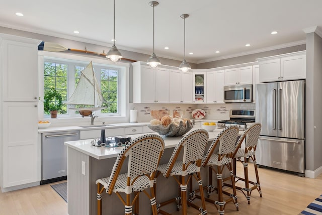 18 Forest Hill Ln, Kennebunk, ME 04043 - kitchen featuring appliances with stainless steel finishes, a sink, light countertops, white cabinetry, and crown molding