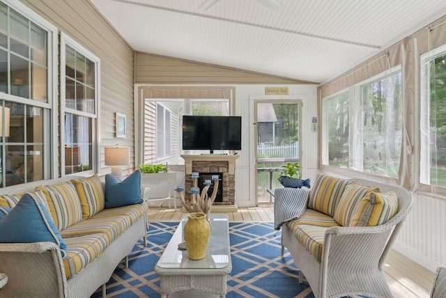 18 Forest Hill Ln, Kennebunk, ME 04043 - sunroom / solarium with an outdoor living space with a fireplace, vaulted ceiling, plenty of natural light, wood walls, and a ceiling fan