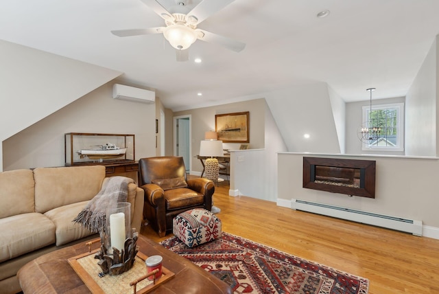 18 Forest Hill Ln, Kennebunk, ME 04043 - living room with a baseboard radiator, a wall mounted air conditioner, wood finished floors, a chandelier, and ceiling fan