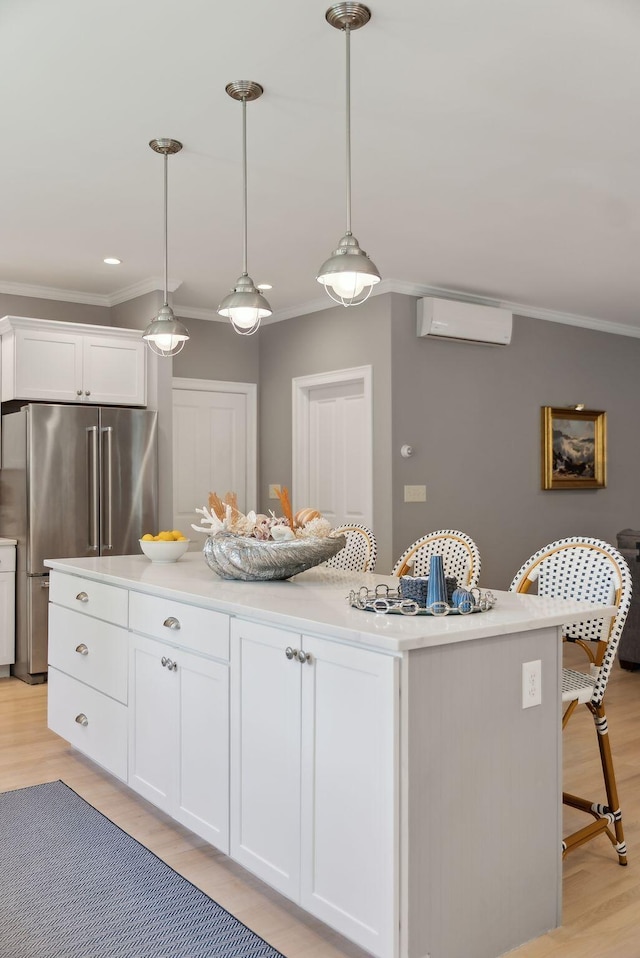 18 Forest Hill Ln, Kennebunk, ME 04043 - kitchen with high end fridge, a wall mounted air conditioner, ornamental molding, light wood-style floors, and a kitchen island