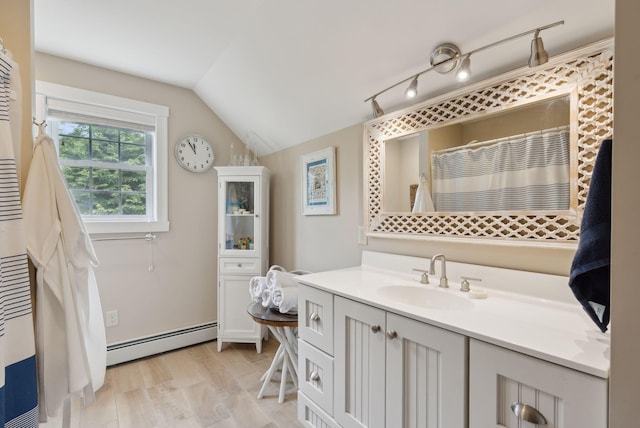 18 Forest Hill Ln, Kennebunk, ME 04043 - bathroom featuring a baseboard heating unit, vanity, and vaulted ceiling