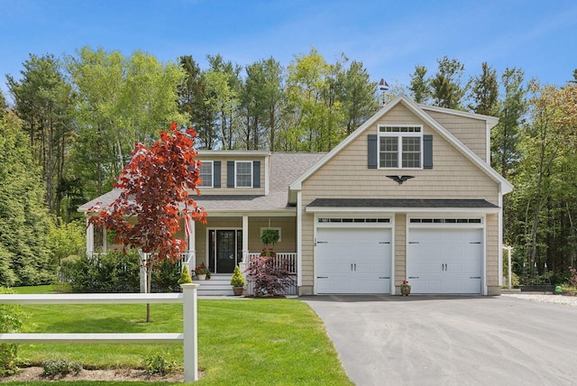 18 Forest Hill Ln, Kennebunk, ME 04043 - view of front of property featuring a porch, a front lawn, driveway, and roof with shingles