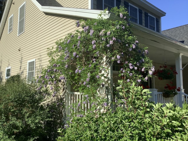 18 Forest Hill Ln, Kennebunk, ME 04043 - view of property exterior with a shingled roof and covered porch