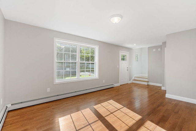 15 Essex St, Westbrook, ME 04092 - unfurnished room featuring wood finished floors, baseboard heating, baseboards, and stairs