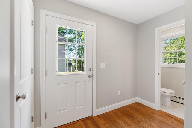 15 Essex St, Westbrook, ME 04092 - entryway with baseboard heating, healthy amount of natural light, light wood-style floors, and baseboards