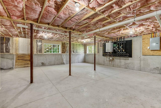 15 Essex St, Westbrook, ME 04092 - below grade area with electric panel, stairway, and tankless water heater