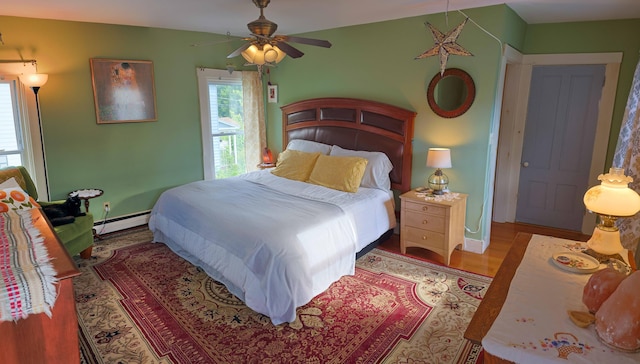 129 Libby St, Pittsfield, ME 04967 - bedroom with a baseboard heating unit and wood finished floors