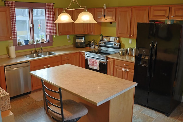 129 Libby St, Pittsfield, ME 04967 - kitchen featuring stainless steel appliances, a sink, light countertops, stone finish floors, and a center island
