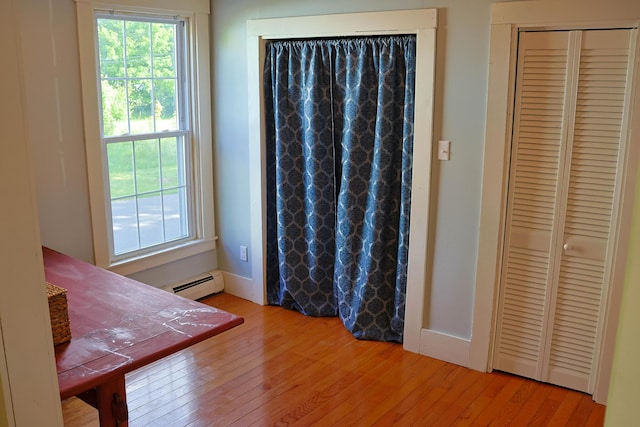 129 Libby St, Pittsfield, ME 04967 - unfurnished bedroom featuring a baseboard heating unit, wood finished floors, and a closet