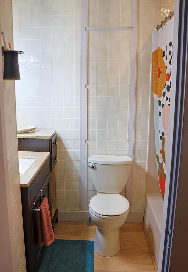 129 Libby St, Pittsfield, ME 04967 - full bath with wood finished floors, tile walls, toilet, vanity, and shower / tub combo