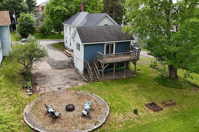 129 Libby St, Pittsfield, ME 04967 - back of property with a wooden deck, a lawn, a fire pit, driveway, and a shingled roof