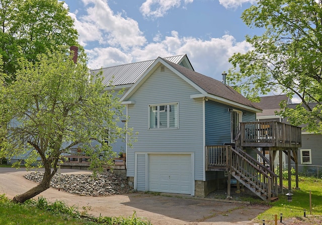 129 Libby St, Pittsfield, ME 04967 - view of side of property featuring driveway, a wooden deck, stairs, and an attached garage