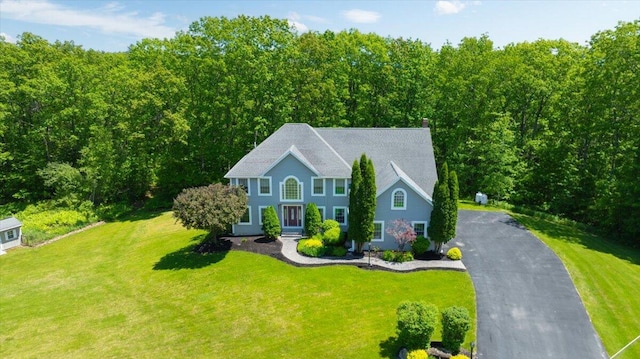 59 Sanderson Rd, Poland, ME 04274 - colonial-style house featuring a front lawn and a chimney